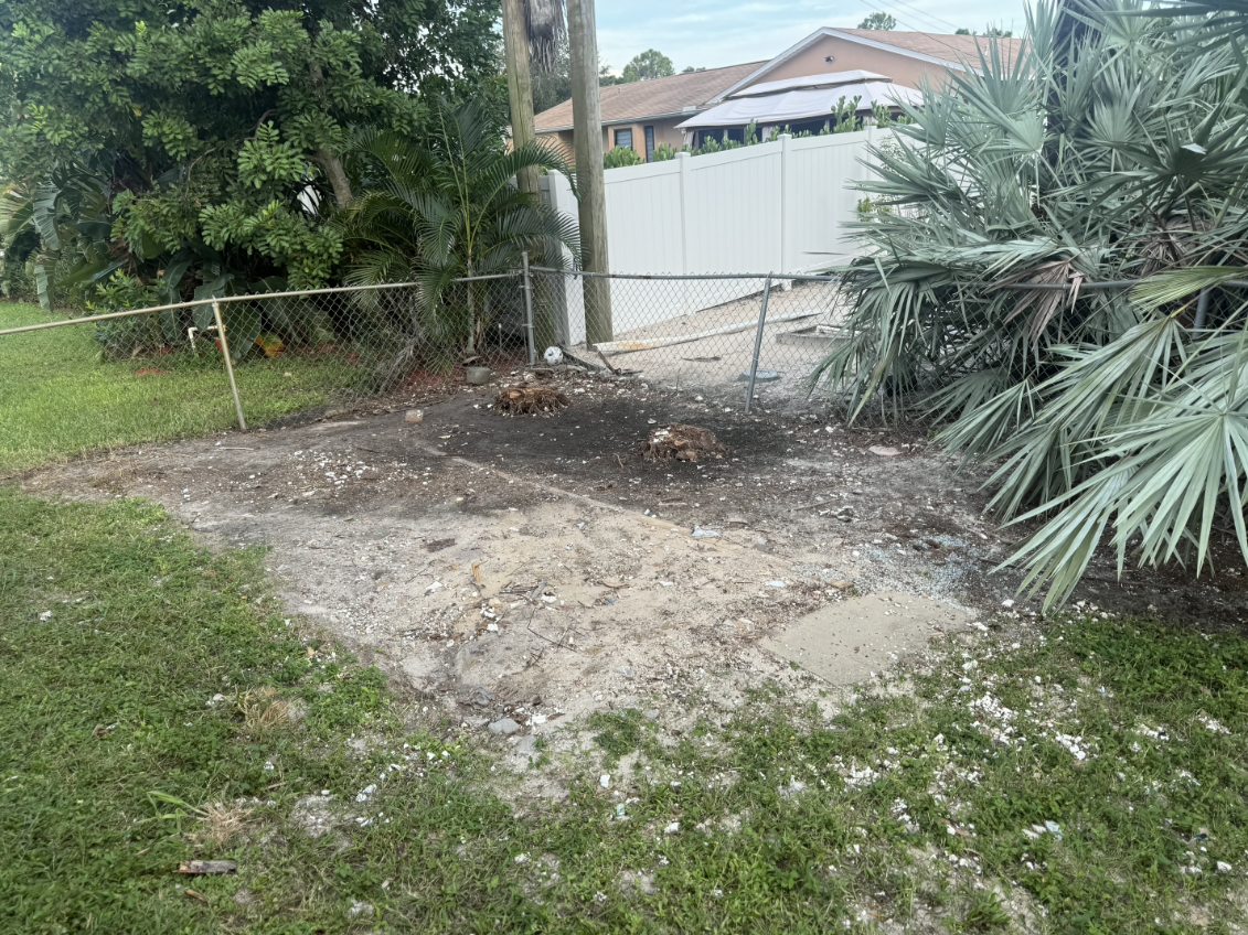 Cleared and raked backyard after shed demolition by Triple H The Trash Kings in Fort Myers FL